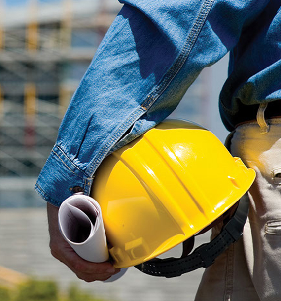 Construction worker holding yellow helmet